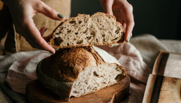 woman with slice of soft homemade bread