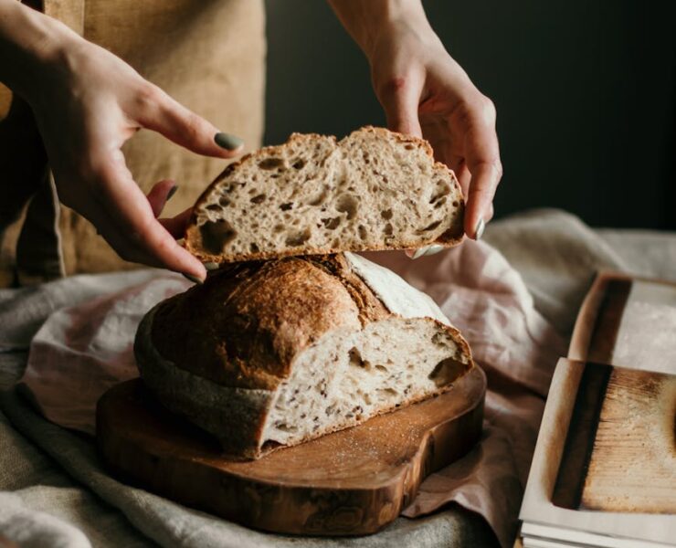woman with slice of soft homemade bread