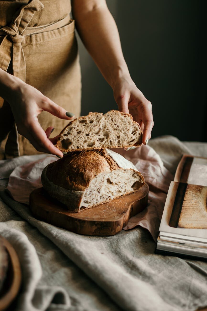 woman with slice of soft homemade bread